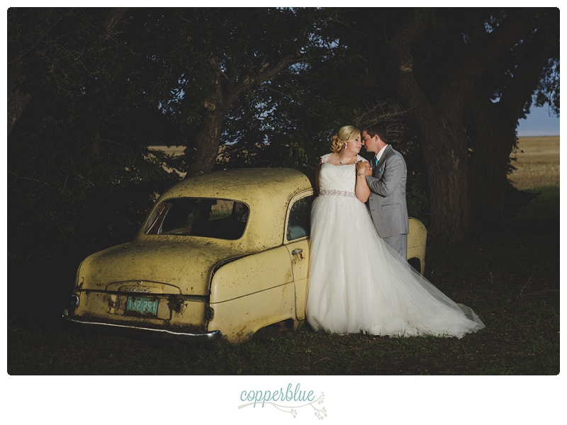 Bride and groom with old car